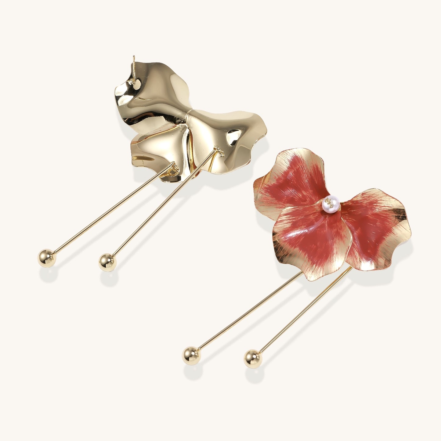 Statement drop earrings with coral-red enamel flower petals, gold-plated brass, and mother-of-pearl centers on white background