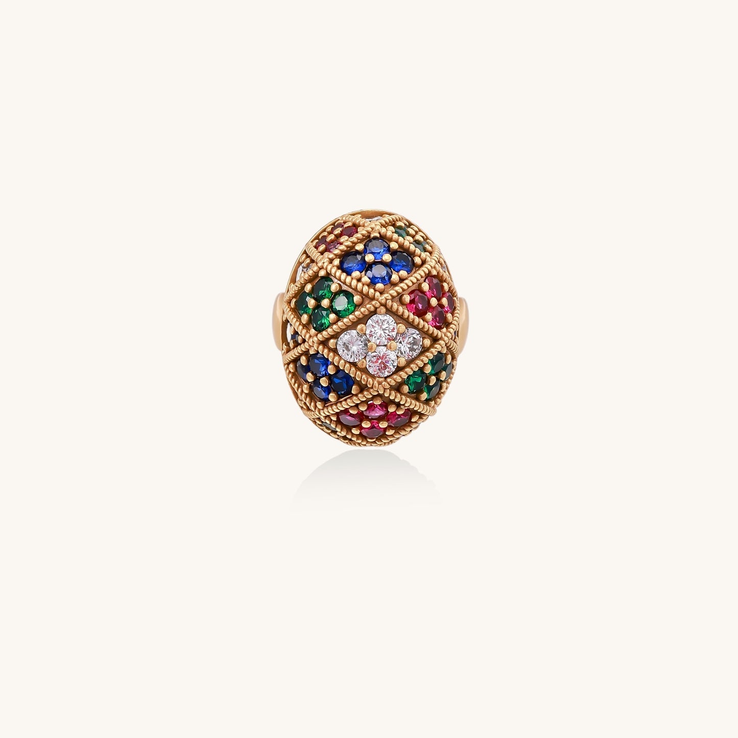 Domed gold-plated ring with geometric mosaic pattern featuring blue, green, red and clear zirconia stones in diamond settings