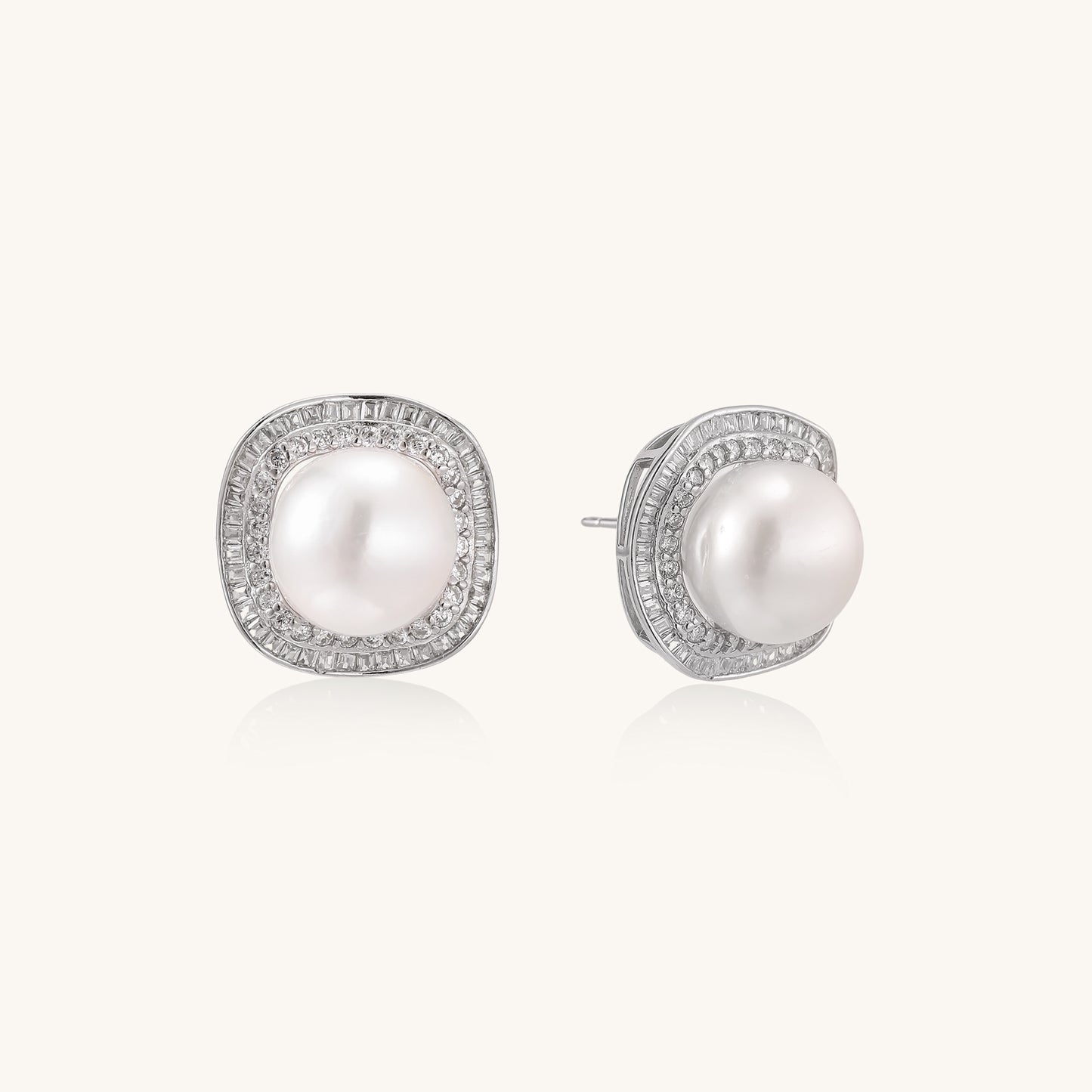 Sterling silver stud earrings with round freshwater pearls surrounded by sparkling crystal halos on white background.
