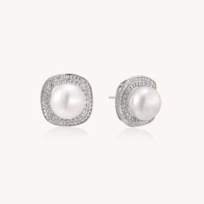 Sterling silver stud earrings with round freshwater pearls surrounded by sparkling crystal halos on white background.