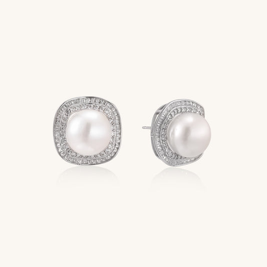 Sterling silver stud earrings with round freshwater pearls surrounded by sparkling crystal halos on white background.
