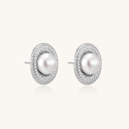 Sterling silver stud earrings with freshwater pearls surrounded by sparkling pavé crystals on white background.