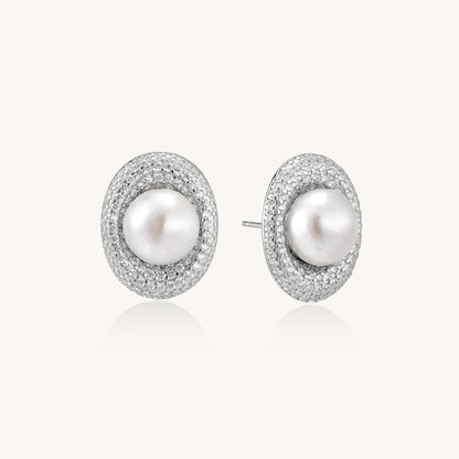 Sterling silver stud earrings with freshwater pearls surrounded by sparkling pavé crystals on white background.