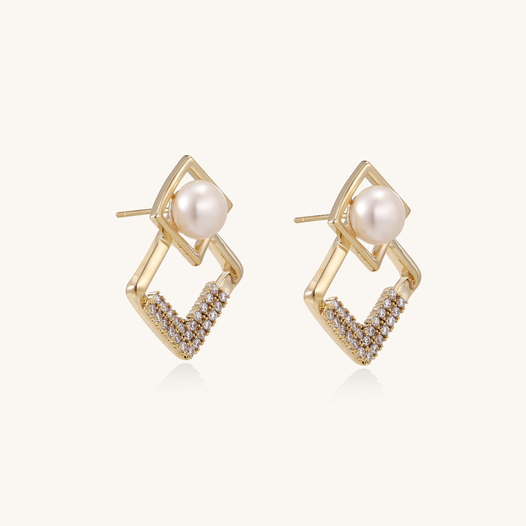 Gold-plated geometric drop earrings with freshwater pearls in square frames and crystal-accented diamond-shaped dangles