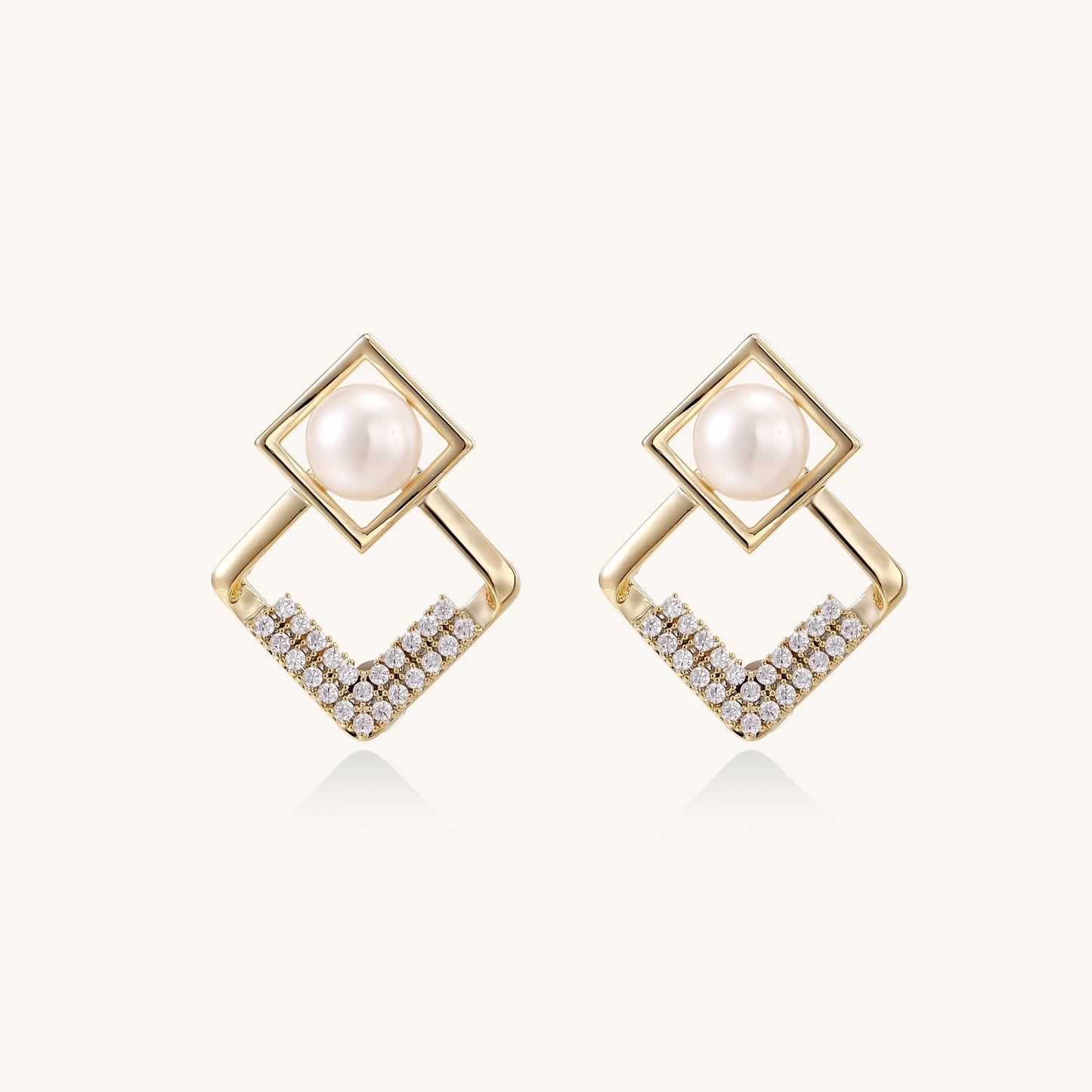 Gold-plated geometric drop earrings with freshwater pearls in square frames and crystal-accented diamond-shaped dangles