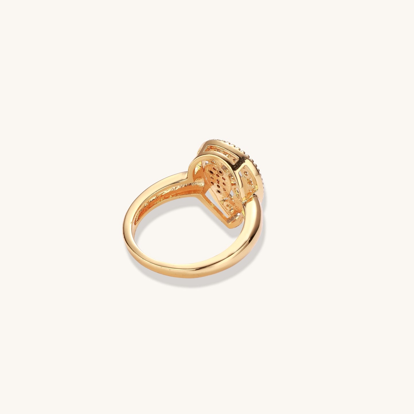 Gold-plated heart ring with turquoise enamel scrollwork and cubic zirconia stones on white background