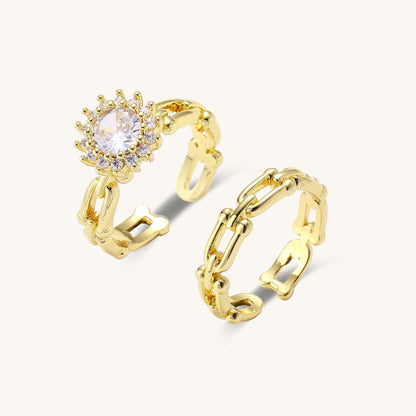 Two gold-plated rings with cubic zirconia halo design and chain-link band on white background, adjustable sizing.