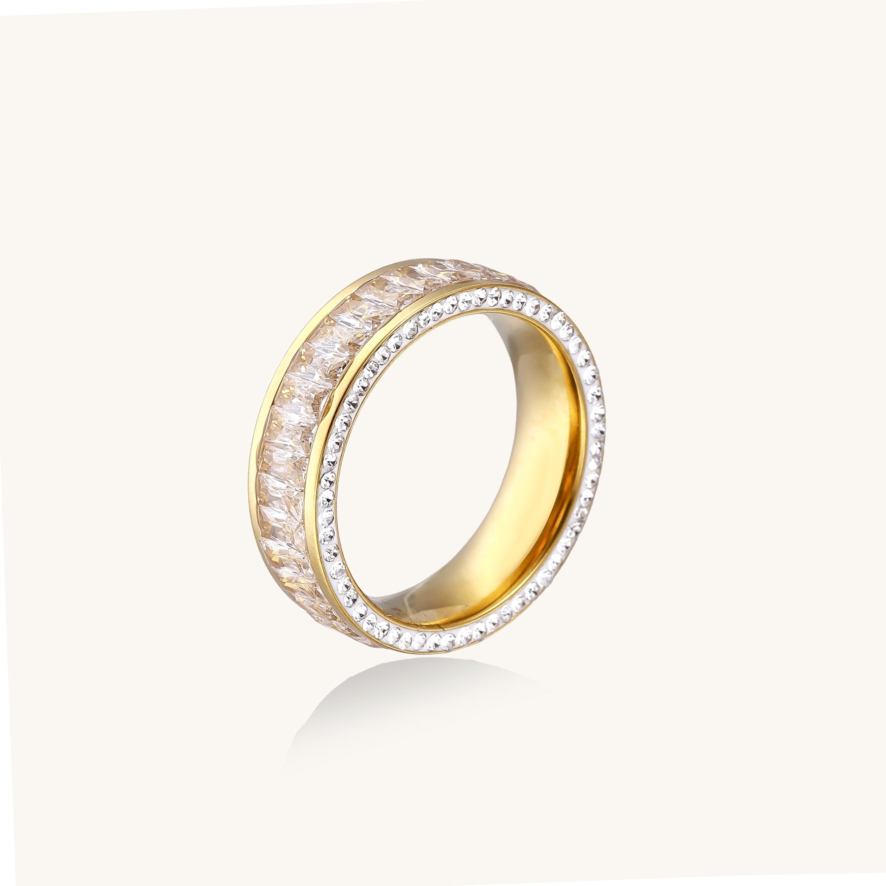 Close-up of a gold-plated eternity ring featuring two parallel rows of brilliant zirconia stones on white background.