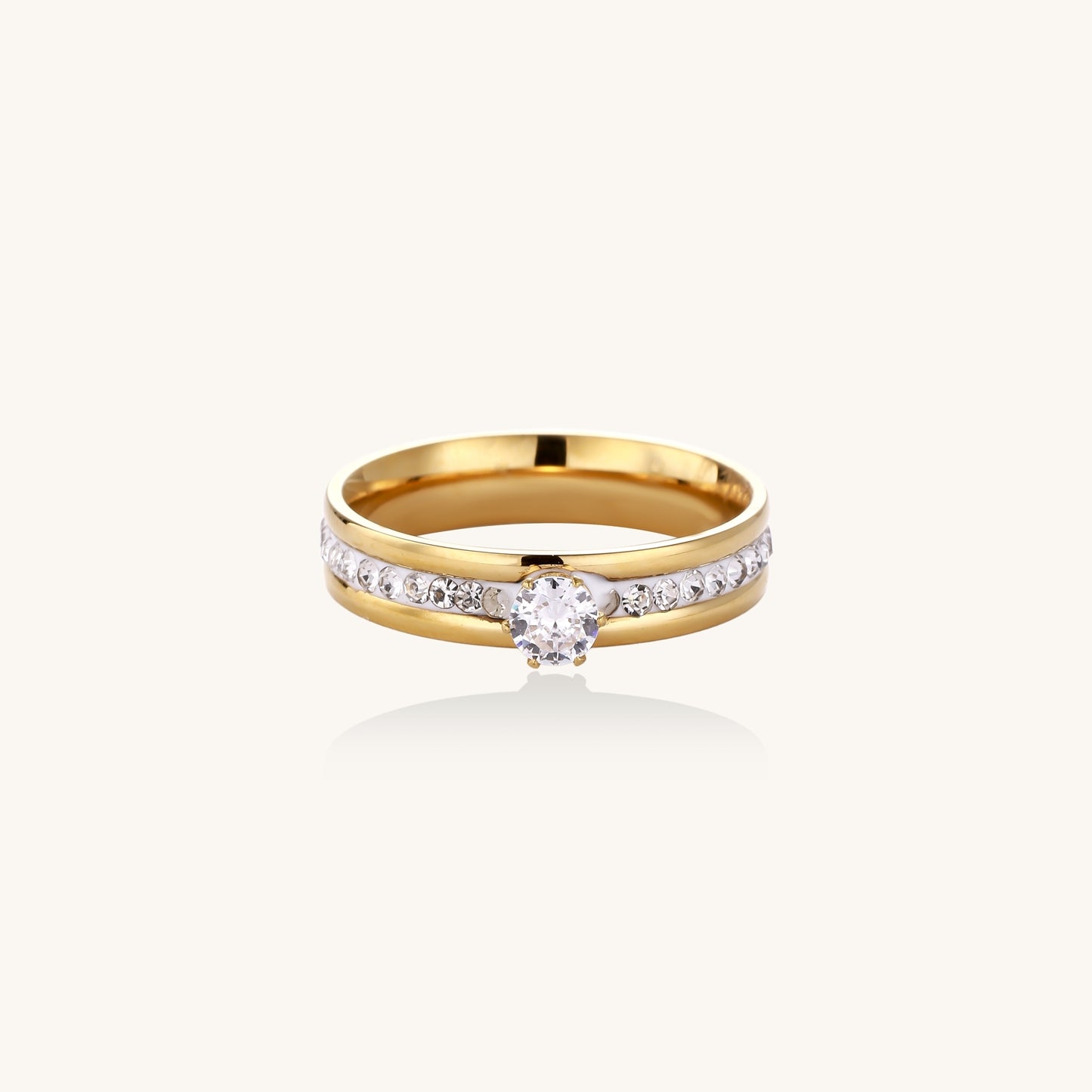 14K gold plated ring with center rhinestone and accent stones along the band on white background.