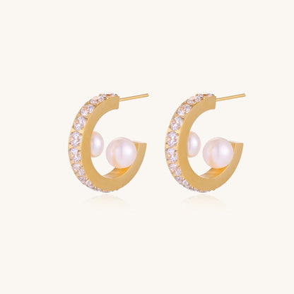 Gold-plated hoop earrings with crystal pavé and floating freshwater pearls inside the circular design.