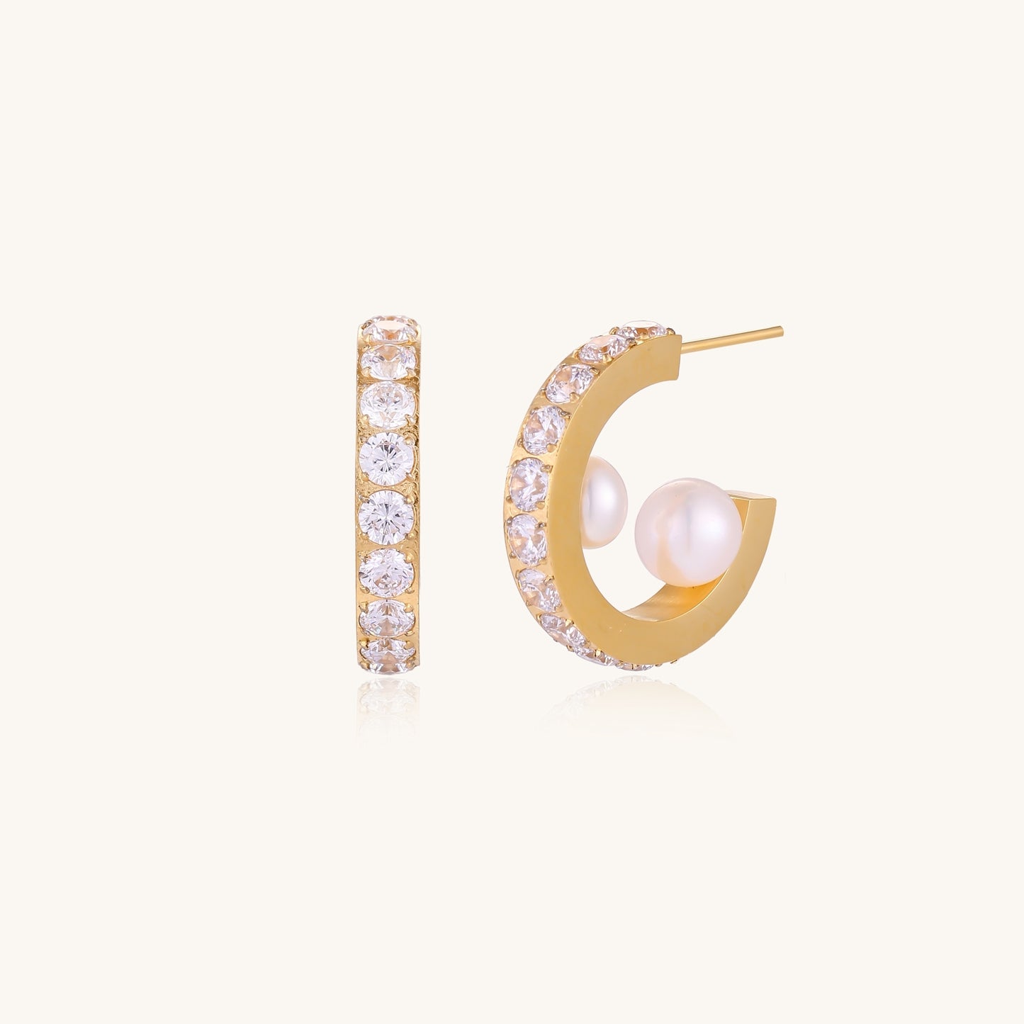 Gold-plated hoop earrings with crystal pavé and floating freshwater pearls inside the circular design.