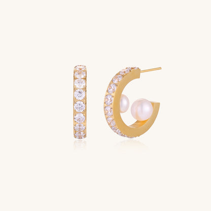 Gold-plated hoop earrings with crystal pavé and floating freshwater pearls inside the circular design.