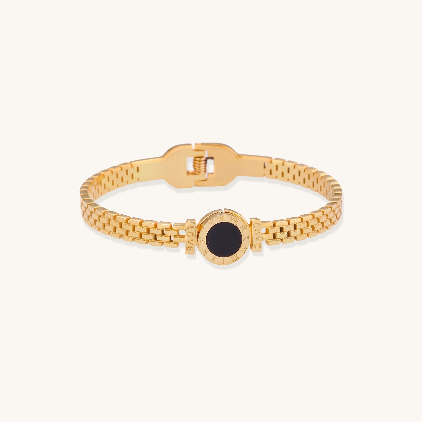 Gold mesh chain bracelet with black mother of pearl centerpiece in circular setting, showing delicate woven pattern