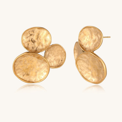 Sculptural gold-plated stainless steel earrings with three hammered oval shapes arranged in artistic cluster formation