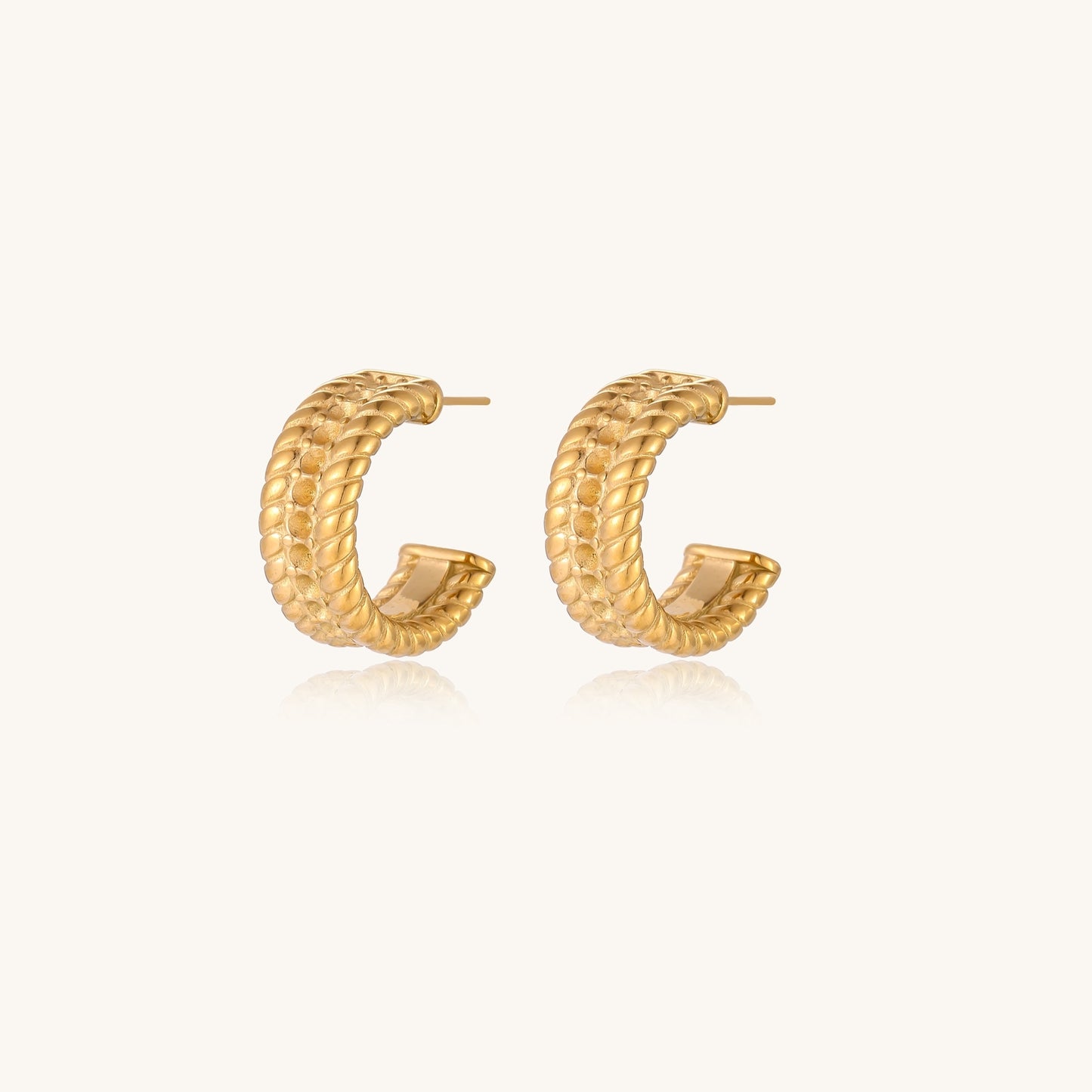 Close-up of 14K gold plated textured hoop earrings with rope pattern against cream background showing convertible design