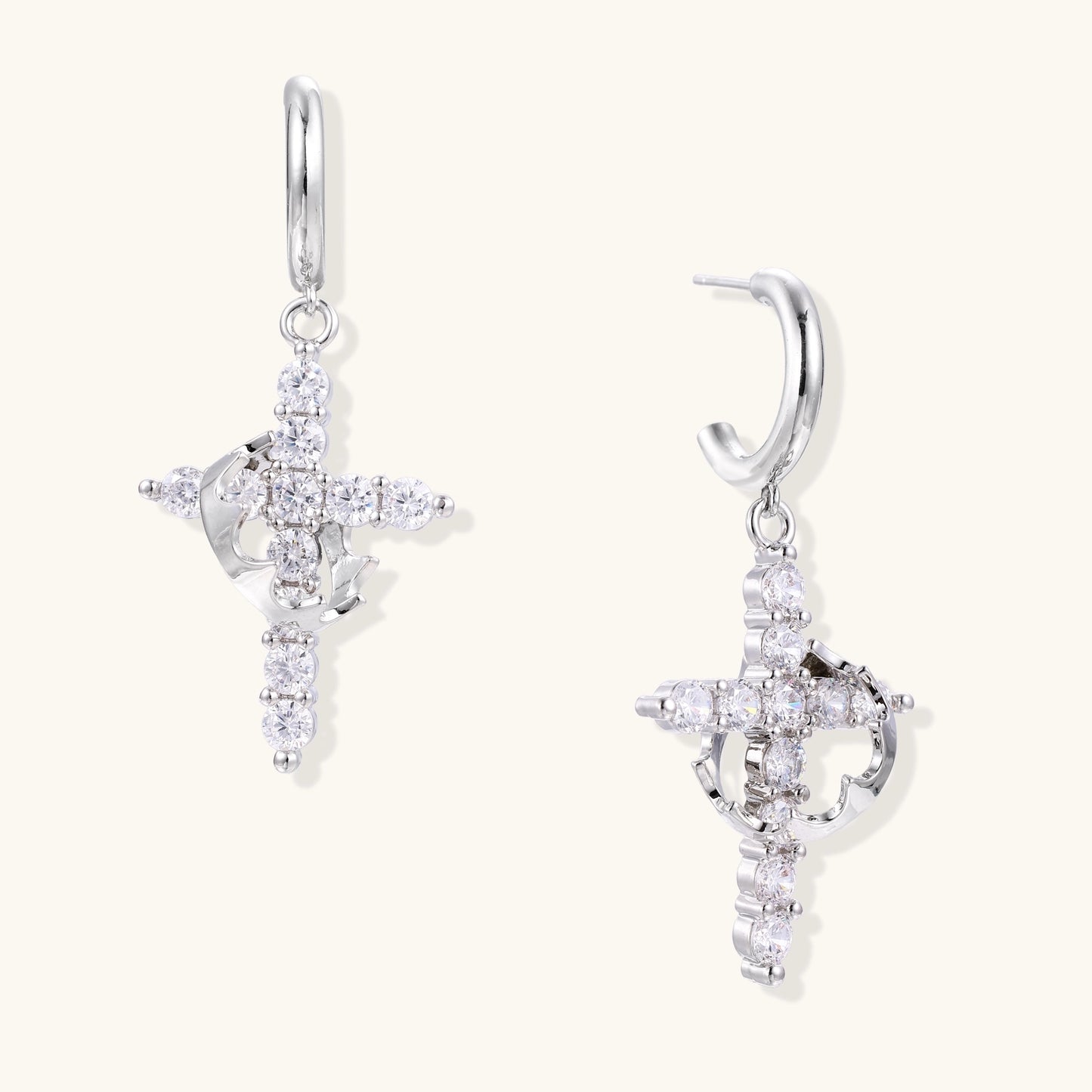 Ornate cross dangle earrings with zirconia stones and gold-plated brass construction on white background.