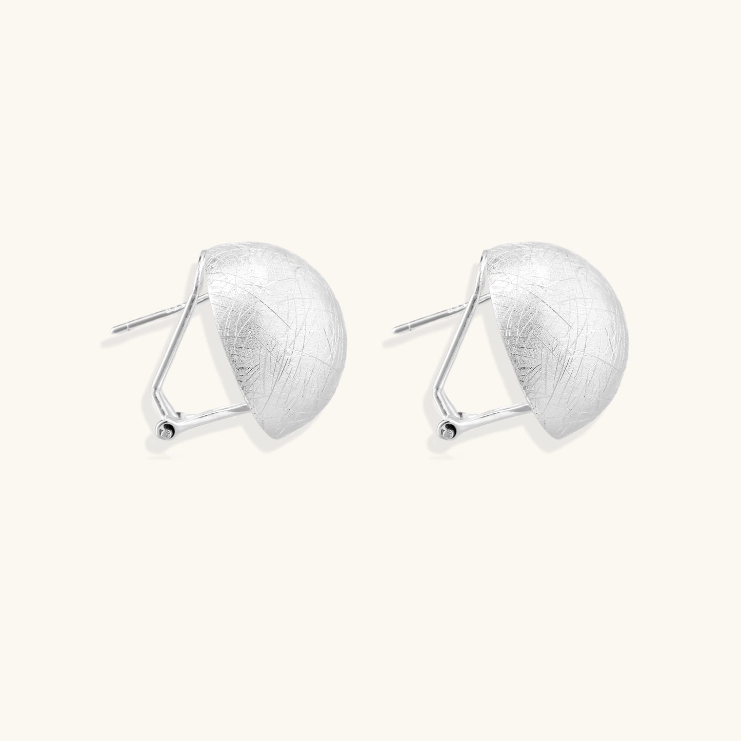 Brushed sterling silver dome-shaped stud earrings with textured surface and secure lever-back closure on white background.