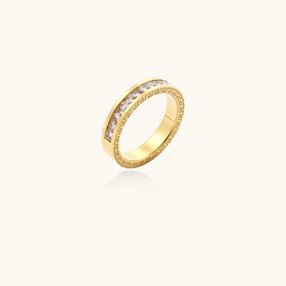 14K gold plated ring with channel-set zirconia stones and Greek key pattern engraved on sides on white background