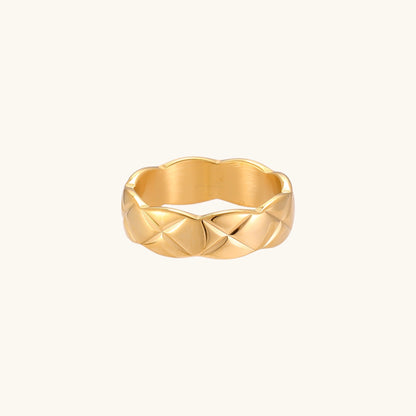 18K gold plated stainless steel ring with geometric twisted band design on neutral background