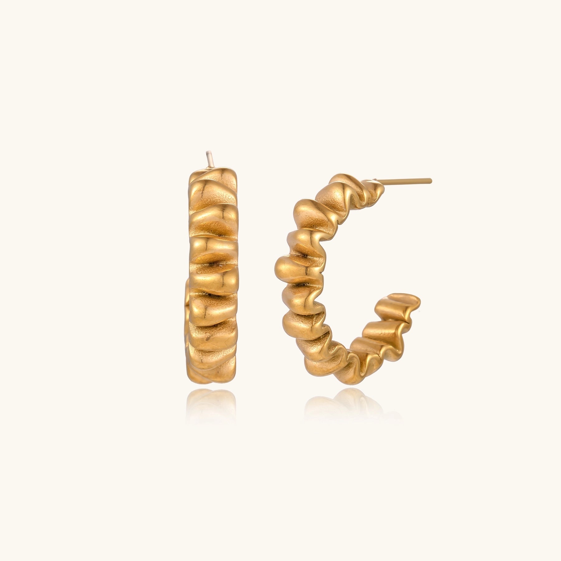 Gold-plated stainless steel earrings with twisted rope texture in various hoop sizes on neutral background.