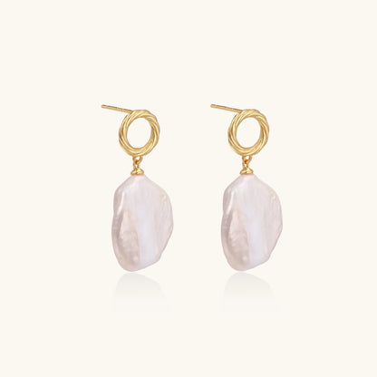 18K gold vermeil twisted circle studs with organic white baroque pearl drops on cream background