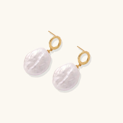 18K gold vermeil twisted circle studs with organic white baroque pearl drops on cream background