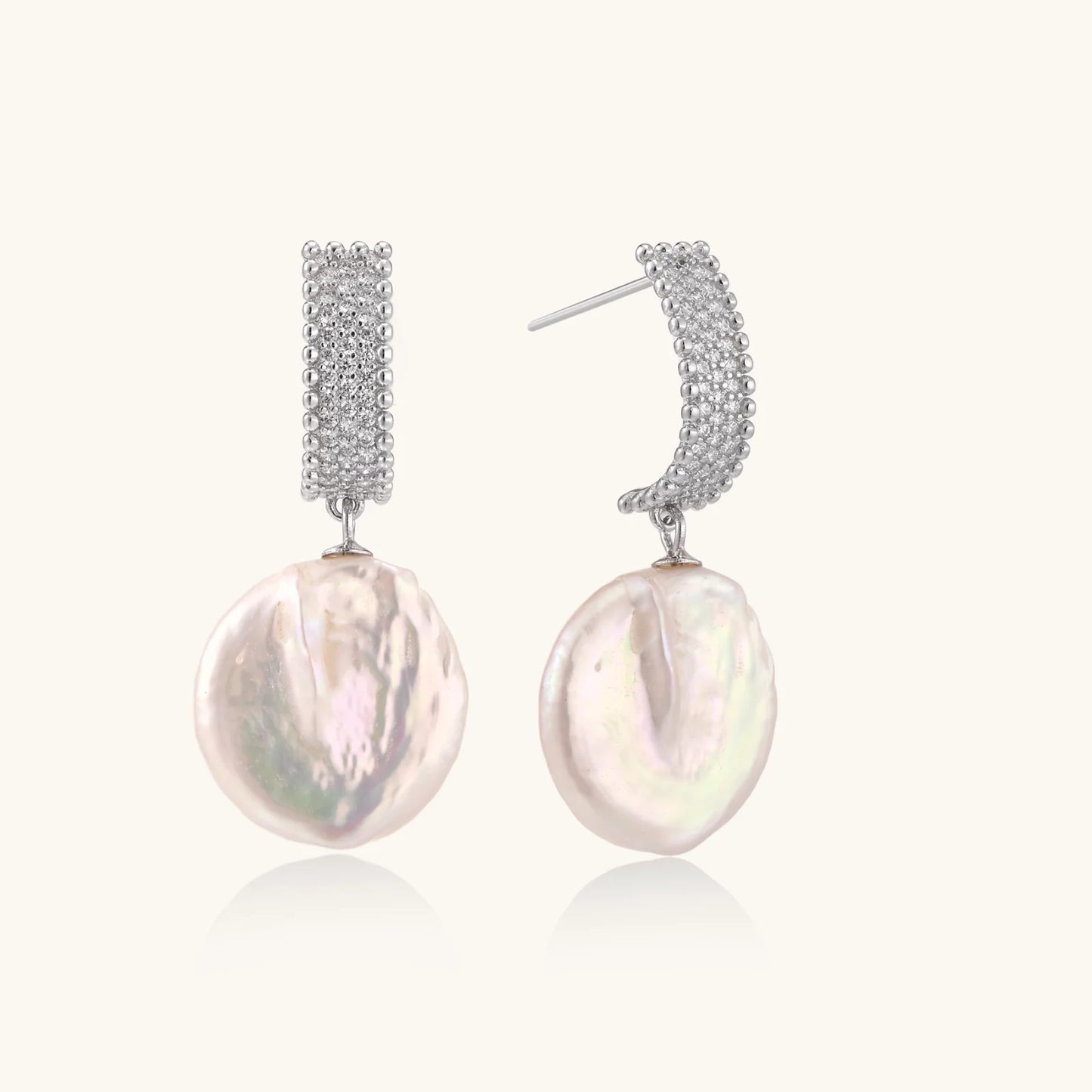Rhodium-plated silver curved stud with pave stones and baroque pearl drop on white background