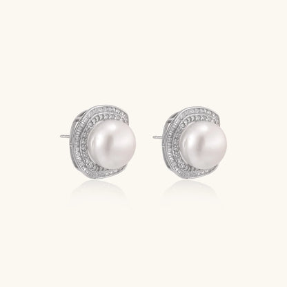 Cushion-shaped sterling silver stud earrings with freshwater pearls surrounded by geometric diamond halos