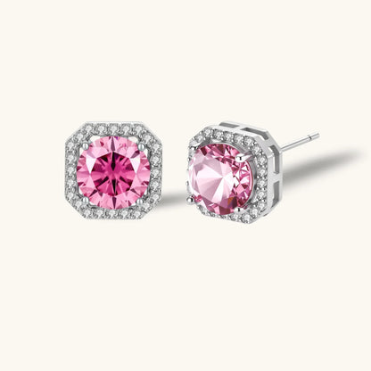 Pink moissanite studs in octagonal sterling silver halo settings with sparkling accent stones on cream background.