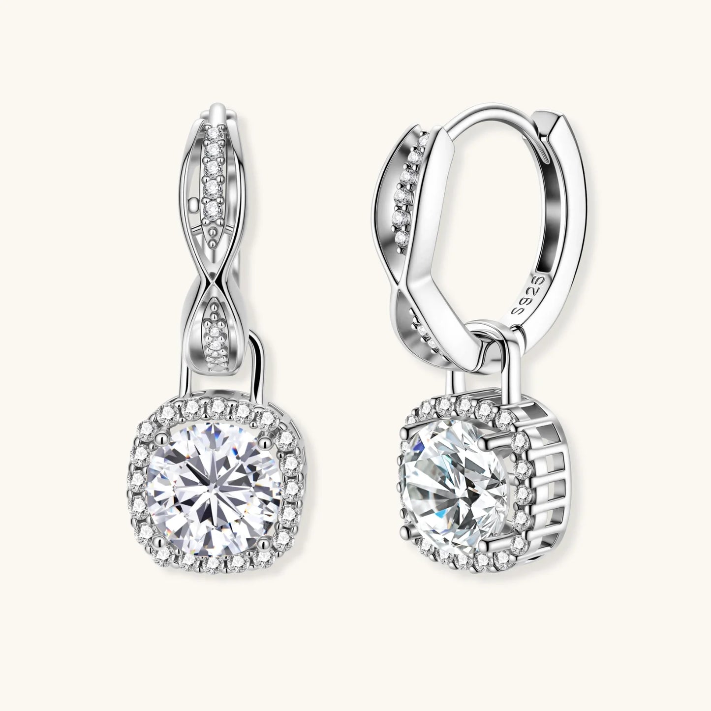 Sterling silver twisted hoop earrings with round moissanite stones in halo settings against neutral background.