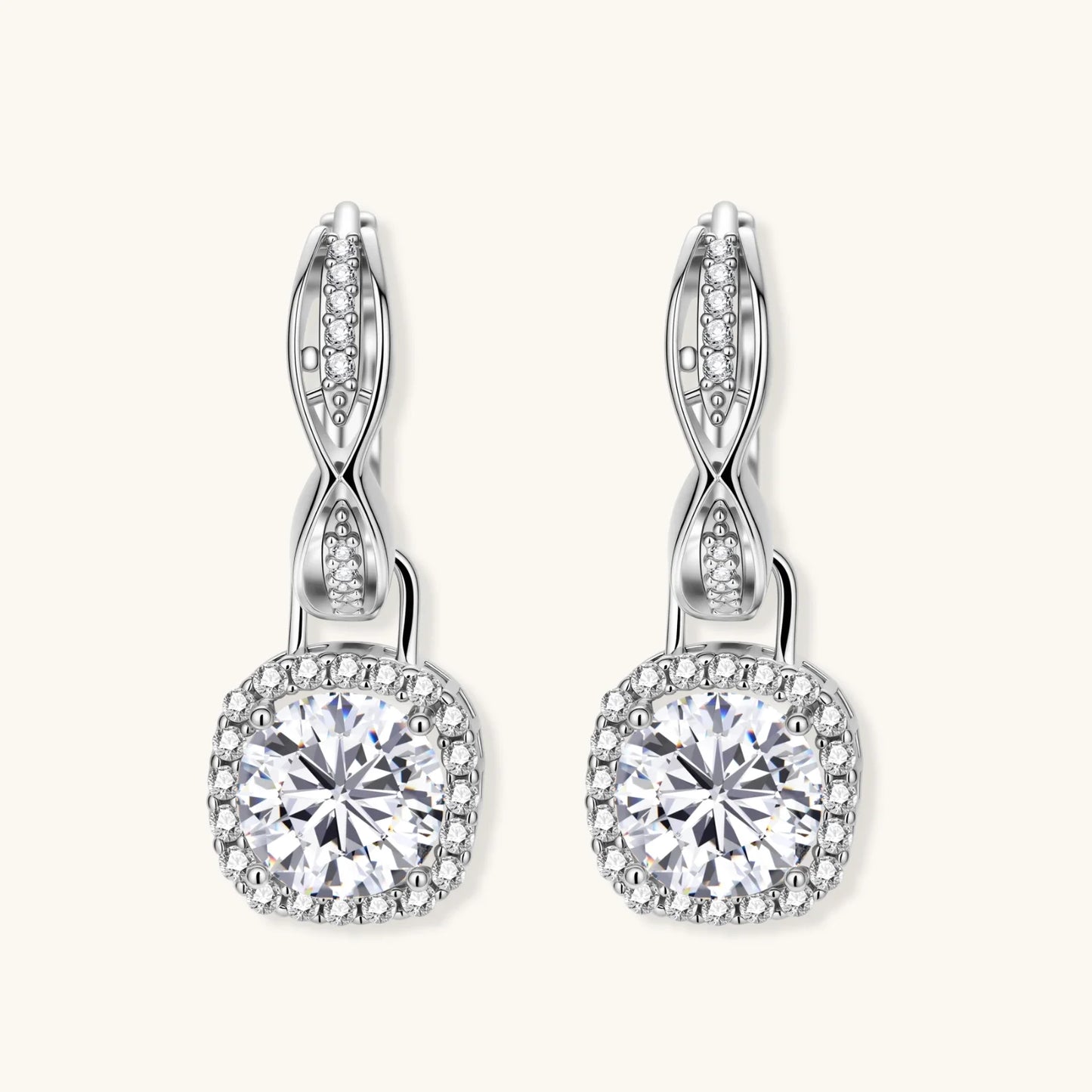 Sterling silver twisted hoop earrings with round moissanite stones in halo settings against neutral background.