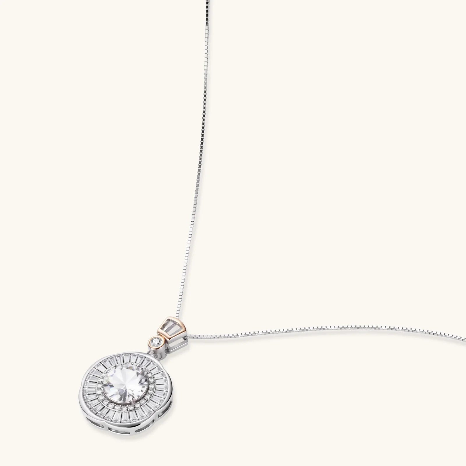 Sterling silver necklace with circular geometric pendant featuring central moissanite and radial baguette pattern.