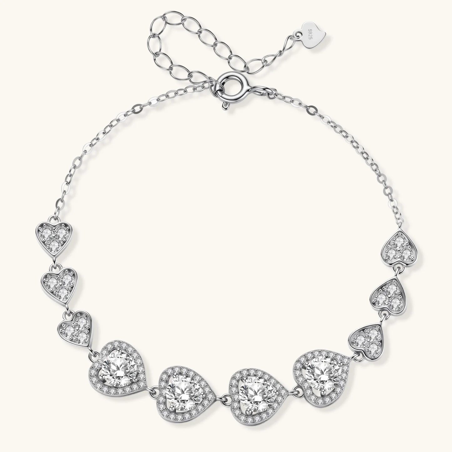 Sterling silver bracelet with graduated heart-shaped links and sparkling moissanite stones in VVS1 clarity on white background.