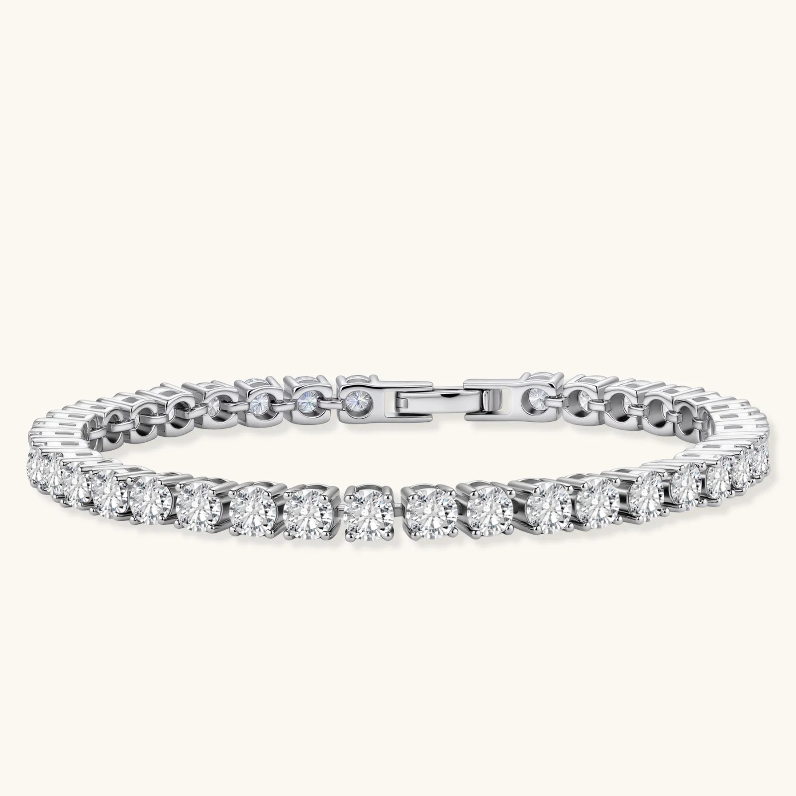 Sterling silver tennis bracelet with continuous row of brilliant moissanite stones and secure clasp closure on cream background.