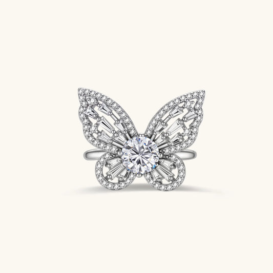 Sterling silver butterfly ring with central moissanite and baguette-cut stones forming intricate wing patterns