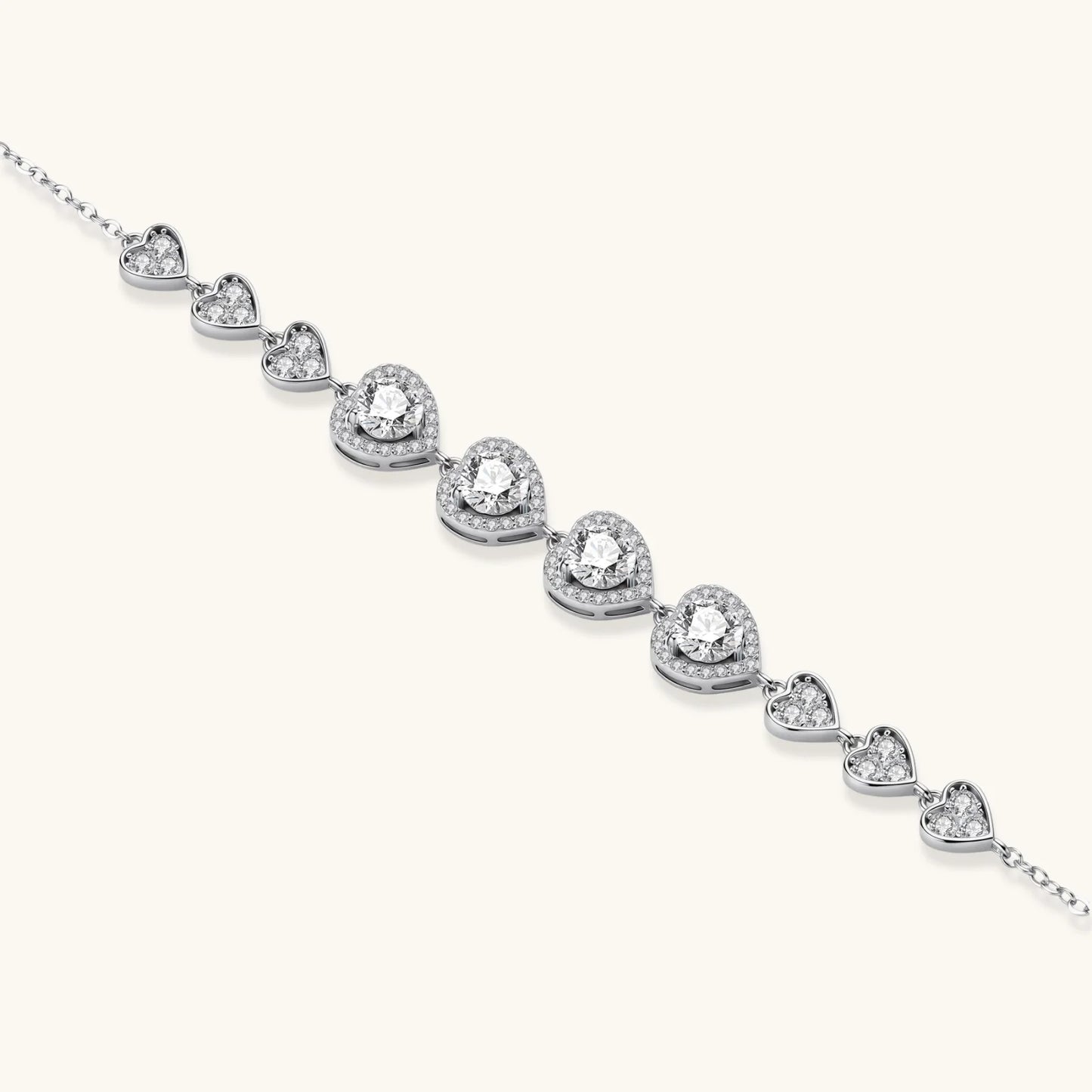 Complete jewelry set with heart-shaped sterling silver pieces featuring brilliant moissanite stones on white background.