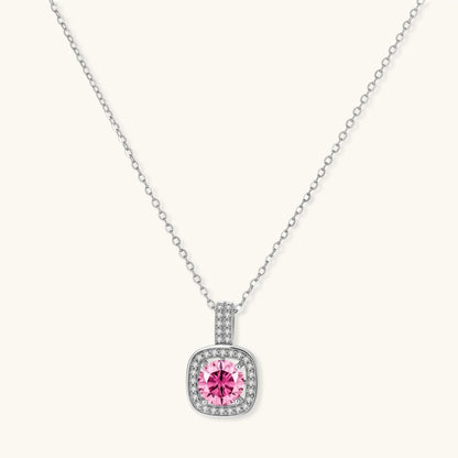 Sterling silver jewelry set featuring pink moissanite stones in halo settings on white background.