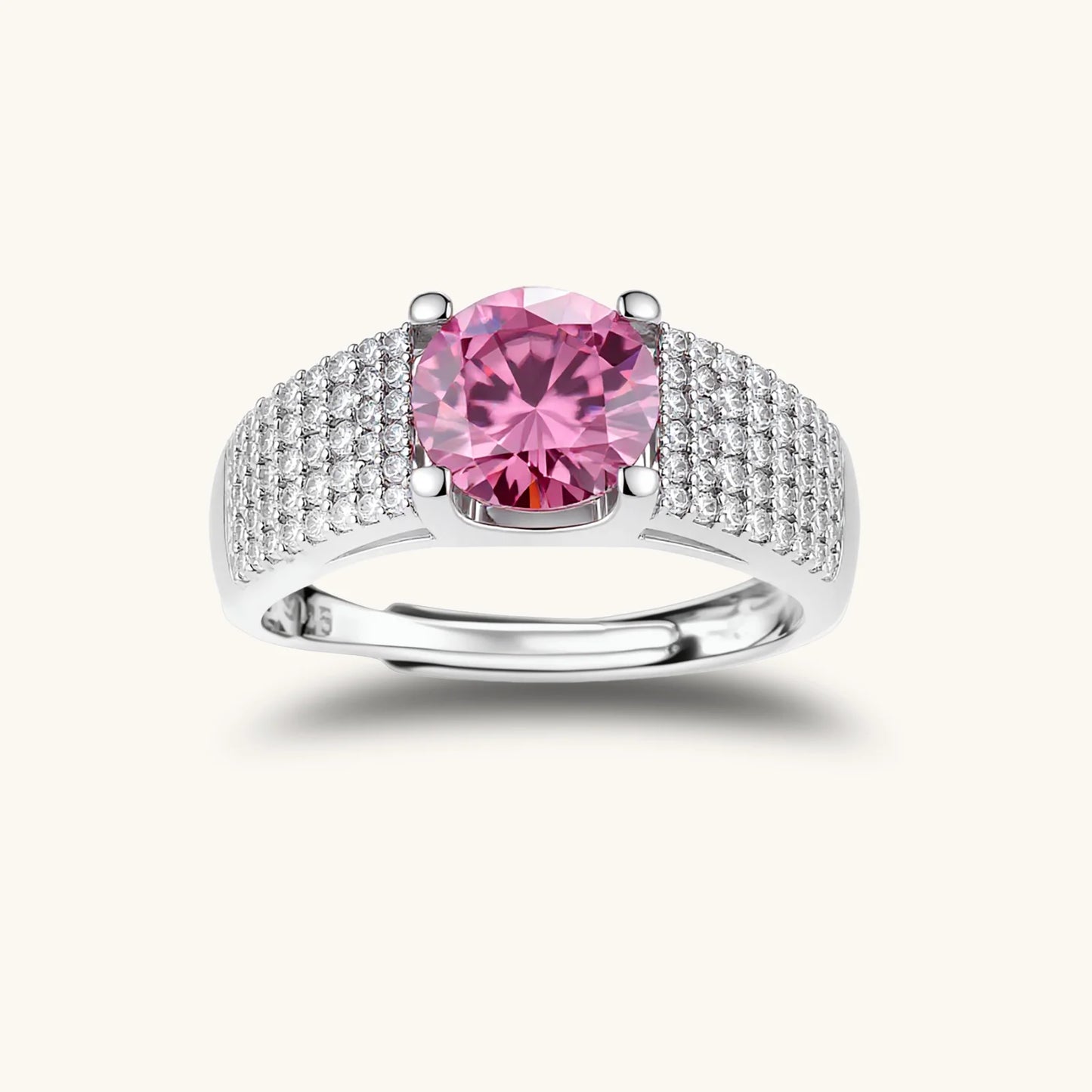 Sterling silver jewelry set featuring pink moissanite stones in halo settings on white background.