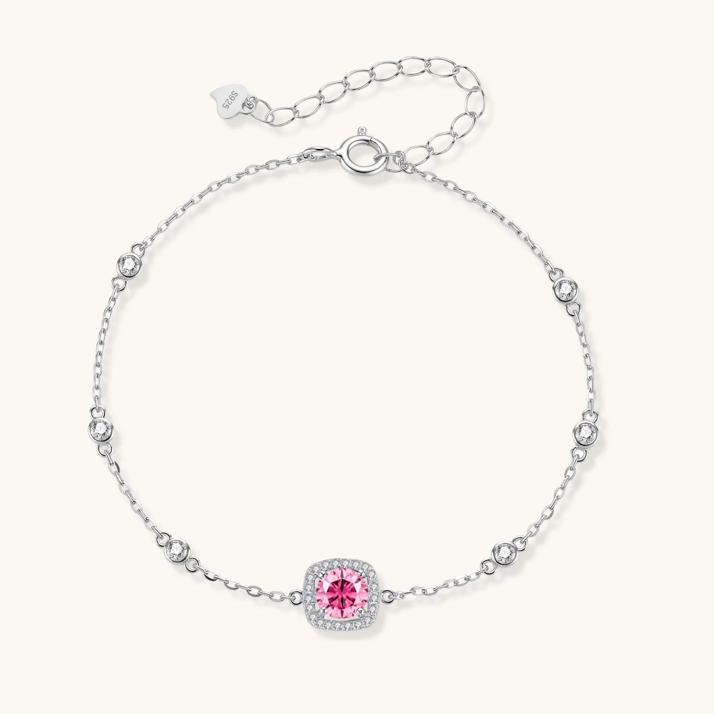 Sterling silver jewelry set featuring pink moissanite stones in halo settings on white background.