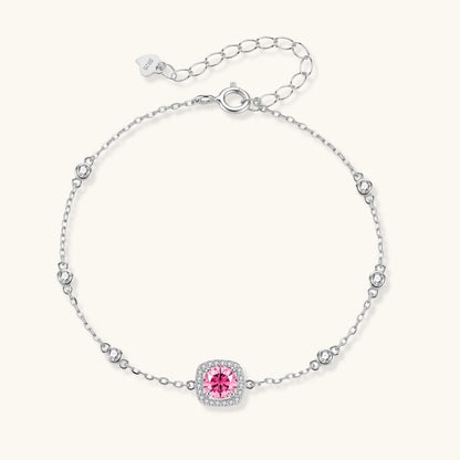 Sterling silver jewelry set featuring pink moissanite stones in halo settings on white background.
