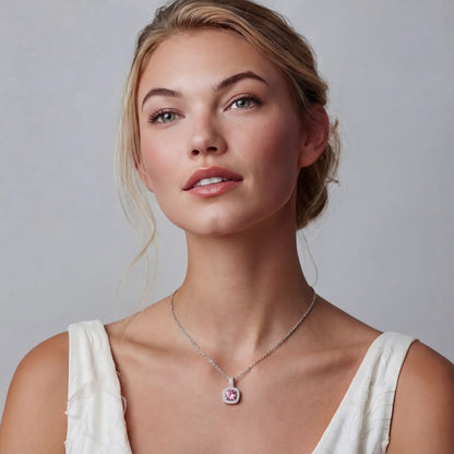Sterling silver jewelry set featuring pink moissanite stones in halo settings on white background.