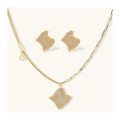 Gold-plated wavy jewelry set with crystal detailing featuring necklace with dual chains and matching textured earrings