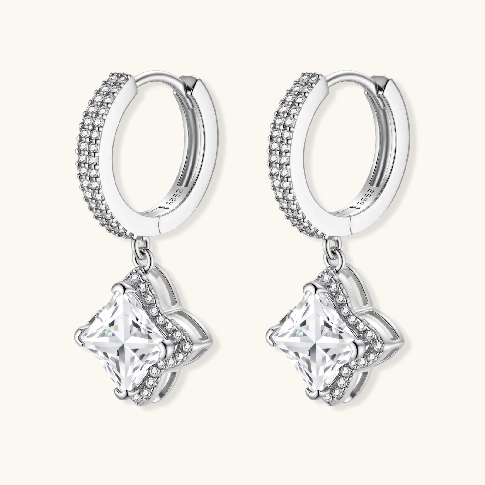 Sterling silver huggie hoops with geometric diamond-shaped moissanite dangles featuring pavé crystal details