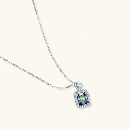 Sterling silver necklace with rectangular rainbow moissanite pendant and teardrop accent stone on white background