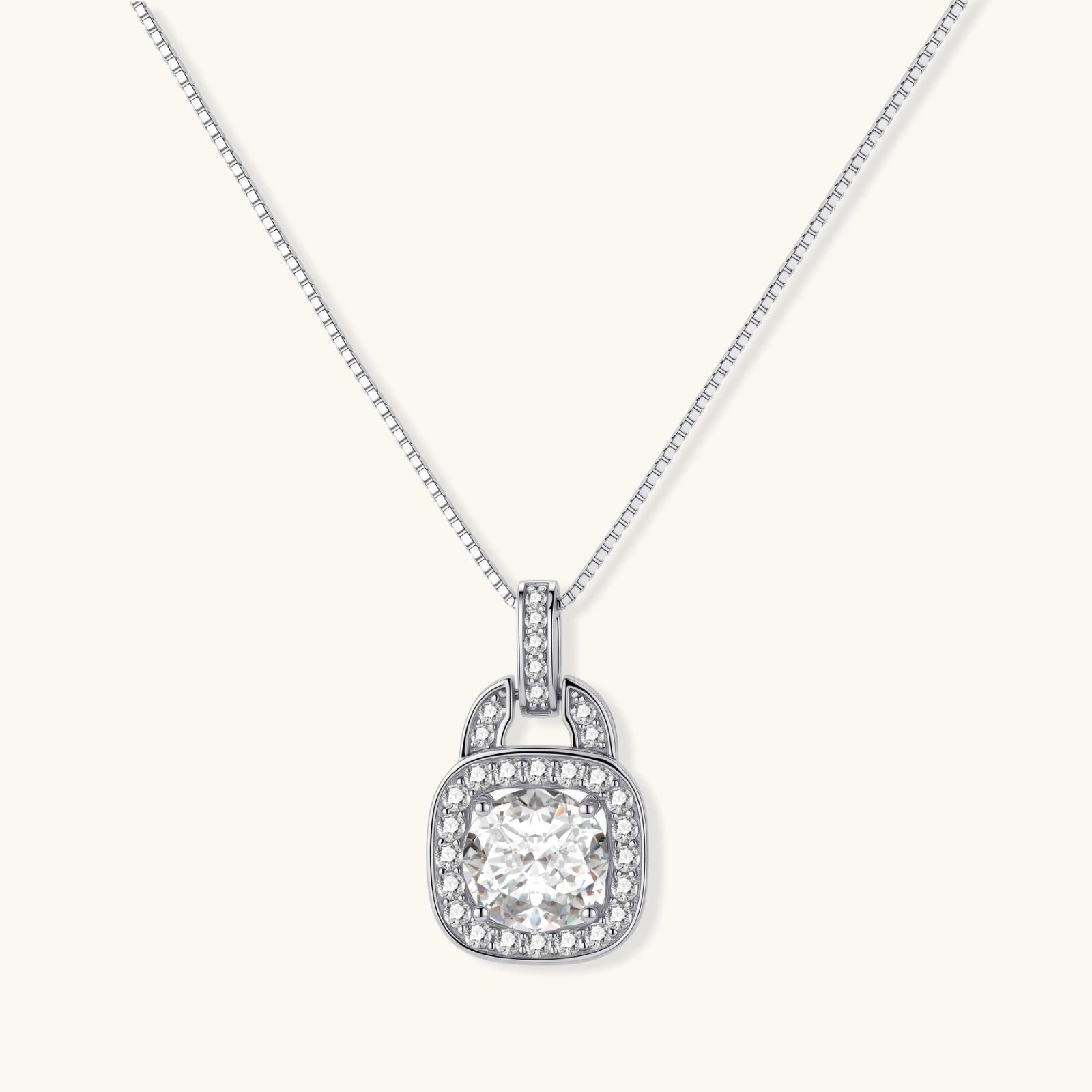 Sterling silver cushion halo pendant necklace featuring 2ct moissanite center stone with delicate box chain on neutral background.
