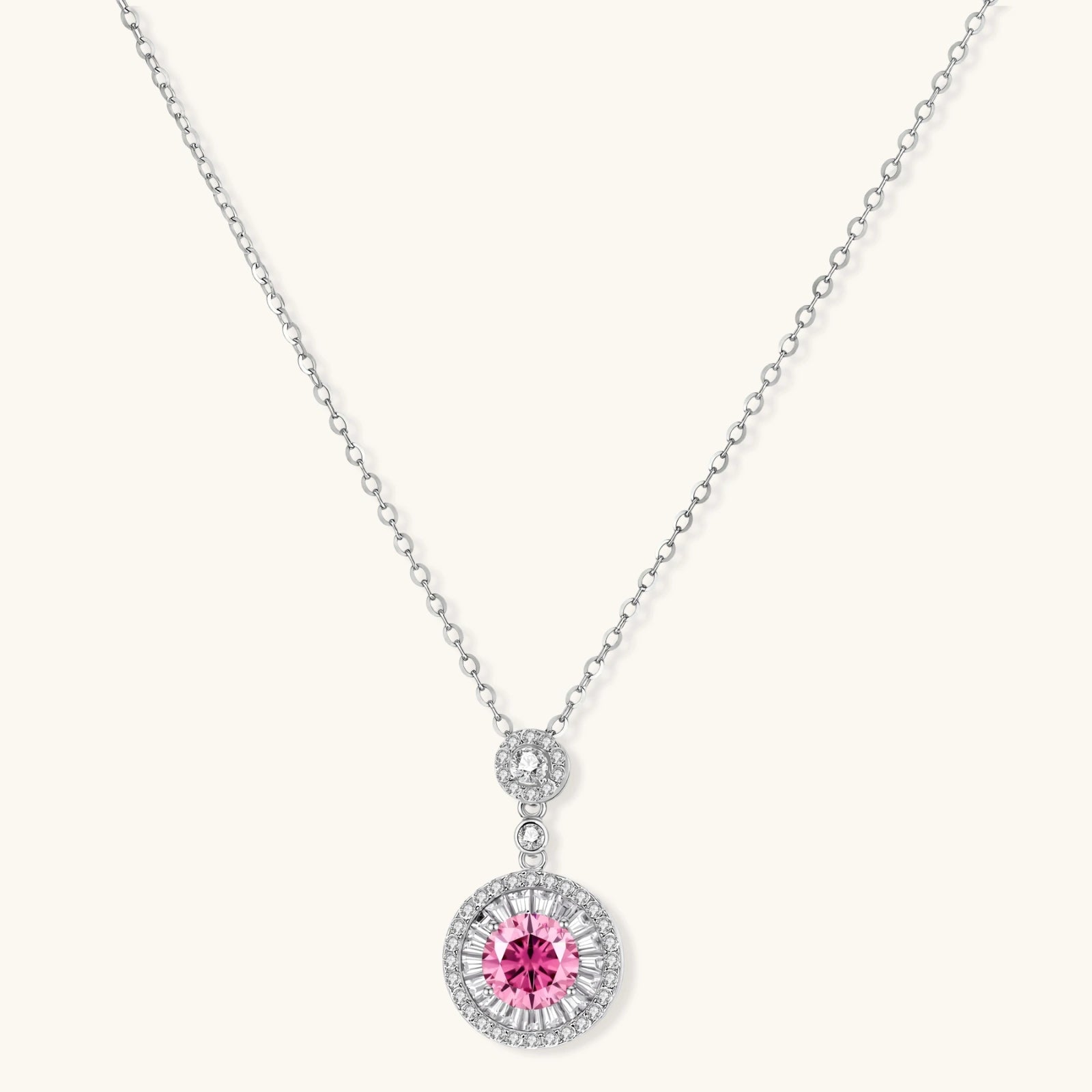 Sterling silver pendant necklace with pink moissanite center stone and clear crystal halo setting on neutral background.