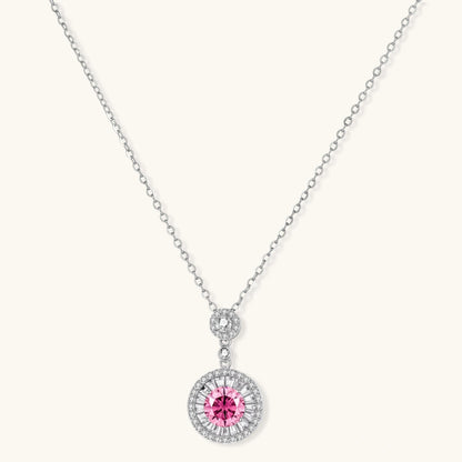 Sterling silver pendant necklace with pink moissanite center stone and clear crystal halo setting on neutral background.