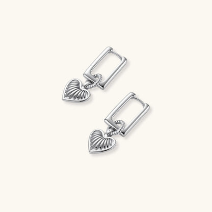 Platinum-plated 925 sterling silver rectangular hoop earrings with twisted ring connector and ribbed heart charm pendant.