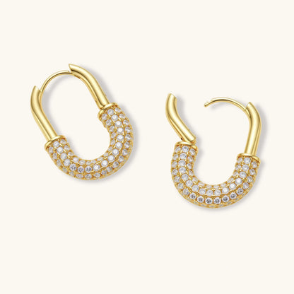 Gold-plated huggie hoop earrings with pavé zirconia stones covering the bottom curve, shown in open and closed positions.