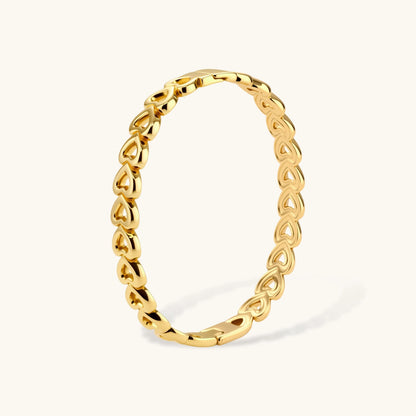 Gold 18K plated stainless steel bangle with continuous open heart links, high-polish finish, on white background.